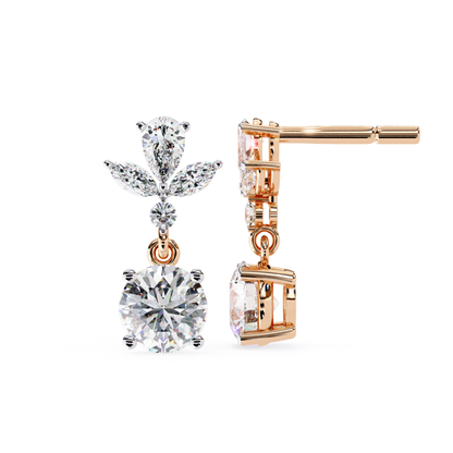 Beautiful rose gold drop earrings with a floral motif, showcasing a dazzling round diamond at the center, complemented by pear-shaped diamonds that add elegance and sparkle to the design.