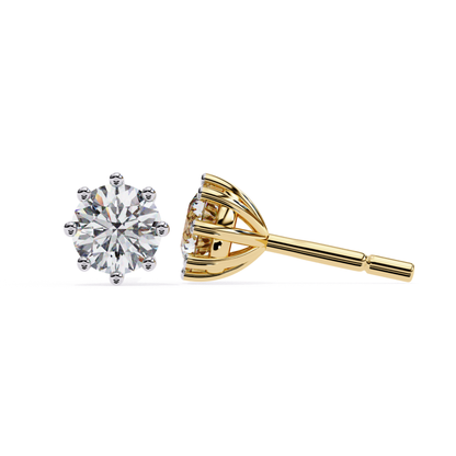  Elegant yellow-gold stud earrings showcasing a brilliant central diamond surrounded by a glowing halo of smaller stones, radiating luxury.