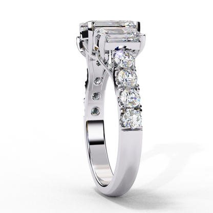 Emerald cut diamond with round side stones
Three stone diamond ring with side diamonds
White gold diamond ring with emerald cut center
Elegant three stone ring with round diamonds
Diamond ring with emerald center stone and side stones
Side view of three stone diamond ring
Three stone diamond ring with white gold band
Emerald cut diamond in a white gold setting
Ring with emerald center and round diamonds
White gold three stone diamond ring