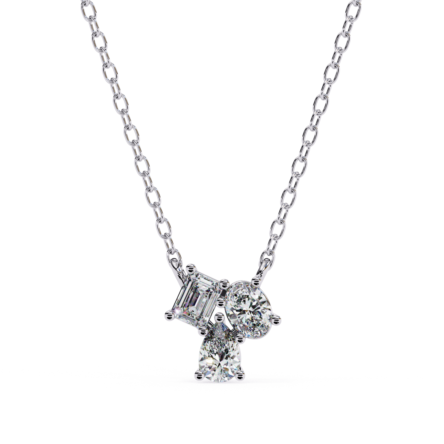 A necklace with emerald, oval, and pear-shaped diamonds set in white gold.