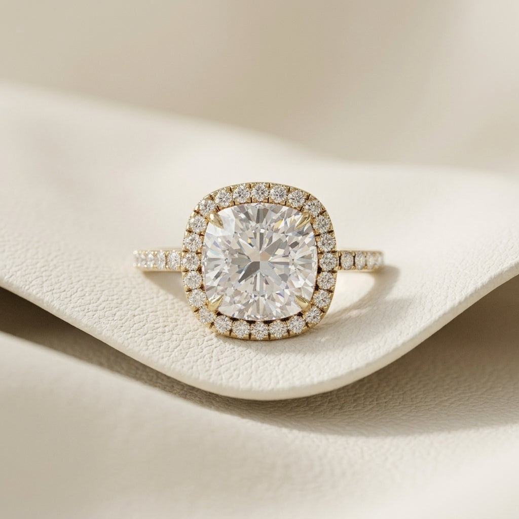 Lab grown cushion cut diamond halo engagement ring in 14K yellow gold
Cushion center diamond framed by a micro-pavé round halo
Yellow gold pavé-set band with matched accent diamonds
IGI certified cushion cut diamond halo ring, front view