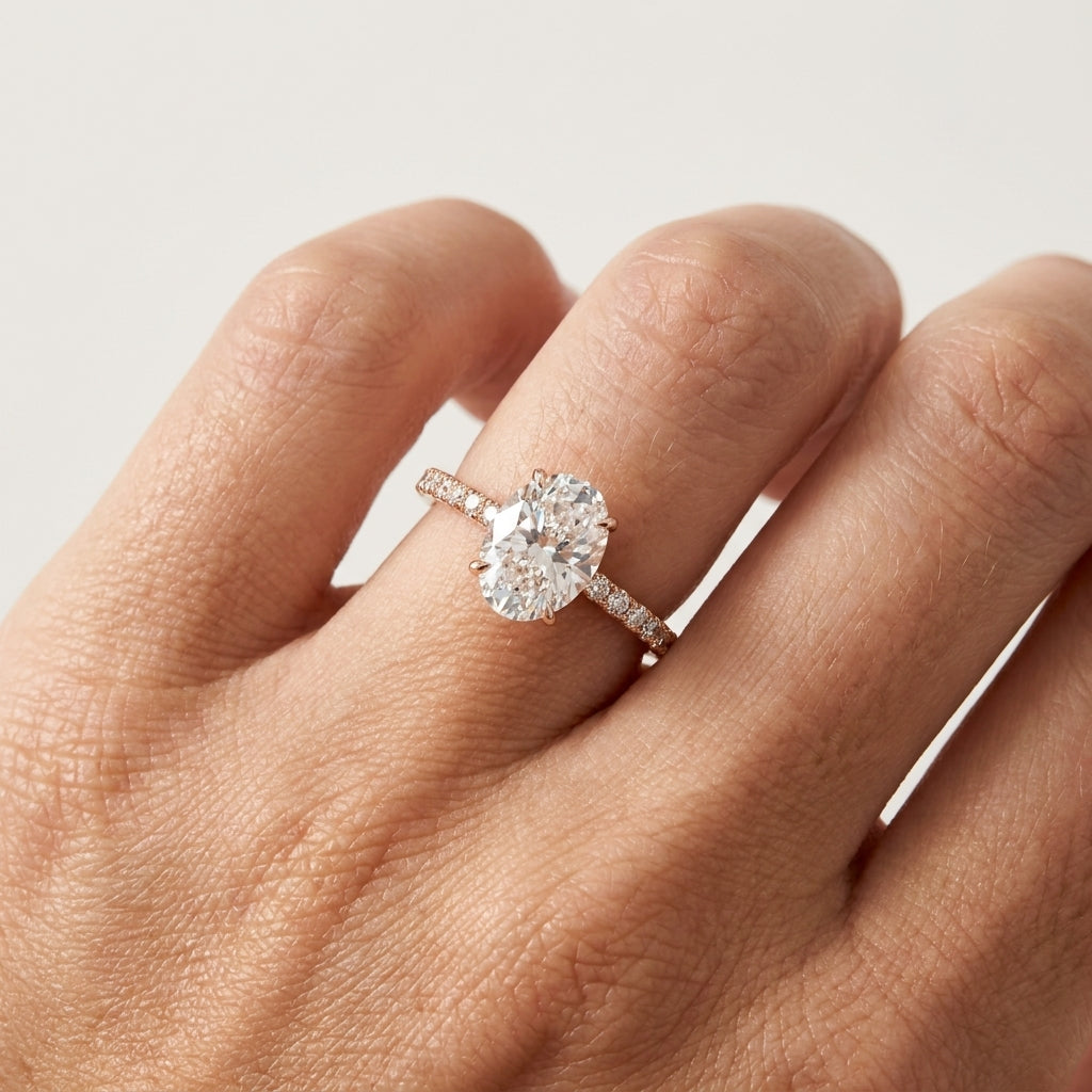 Lab grown oval cut diamond solitaire engagement ring in 14K yellow gold
Oval center diamond in a four-prong claw setting
Yellow gold pavé-set band with matched accent diamonds
IGI certified oval cut diamond solitaire ring, front view