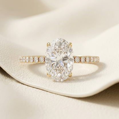 Lab grown oval cut diamond solitaire engagement ring in 14K yellow gold
Oval center diamond in a four-prong claw setting
Yellow gold pavé-set band with matched accent diamonds
IGI certified oval cut diamond solitaire ring, front view