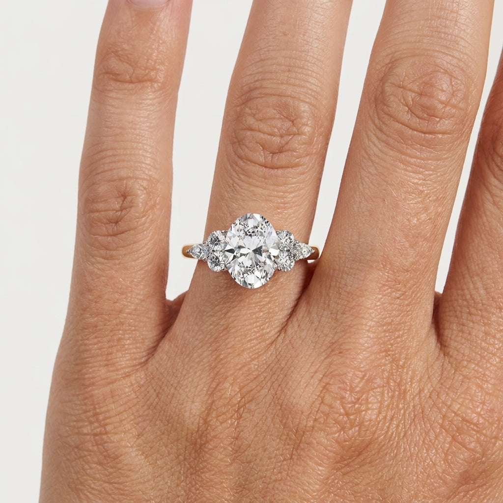 Oval lab grown diamond cluster engagement ring in 14K yellow gold
Prong-set oval center diamond with round and marquise accent clusters
E-F color VVS-VS lab grown diamond three-position cluster ring
Yellow gold oval cut diamond engagement ring, front view