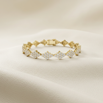 Round lab grown diamond floral link tennis bracelet in yellow gold.
