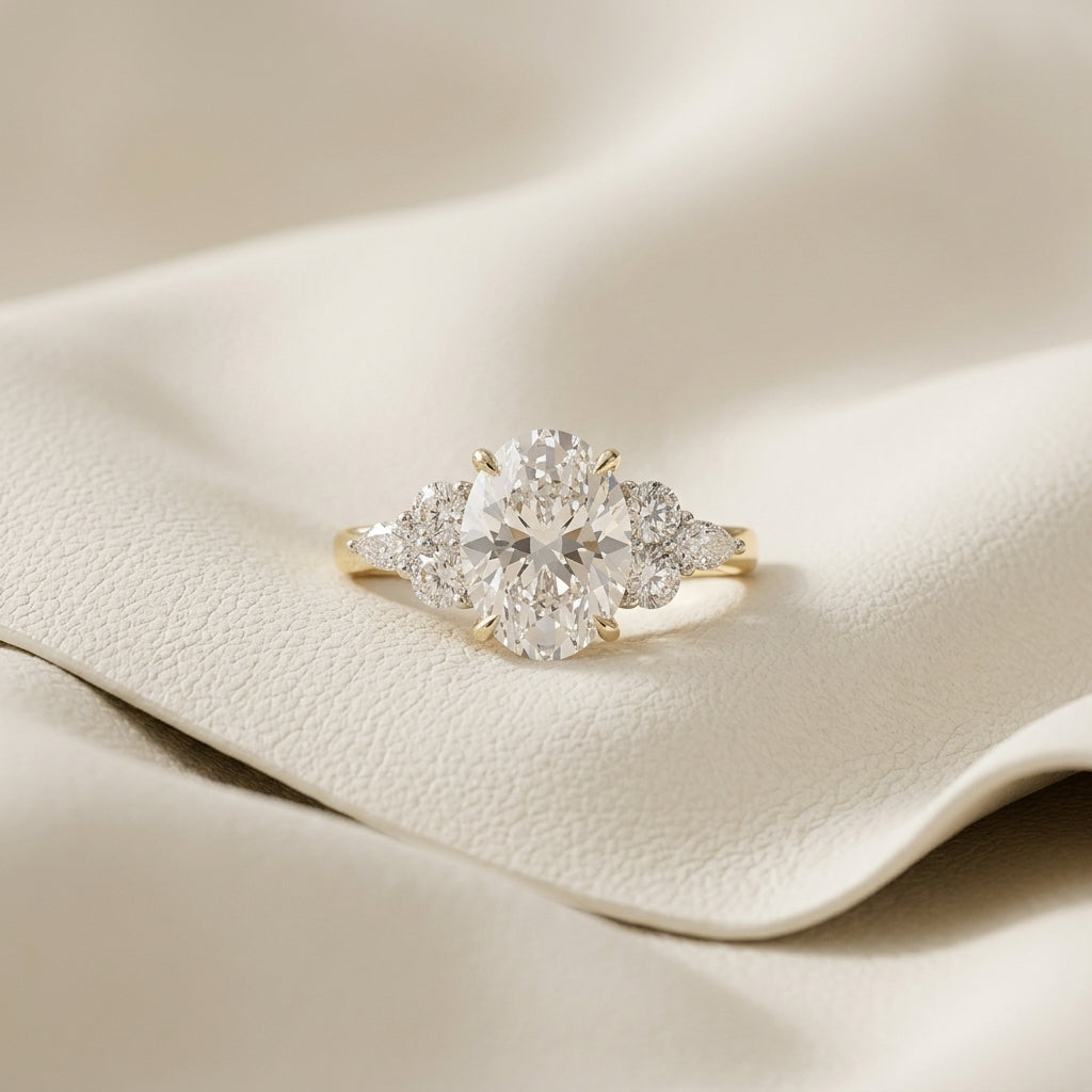 Oval lab grown diamond cluster engagement ring in 14K yellow gold
Prong-set oval center diamond with round and marquise accent clusters
E-F color VVS-VS lab grown diamond three-position cluster ring
Yellow gold oval cut diamond engagement ring, front view