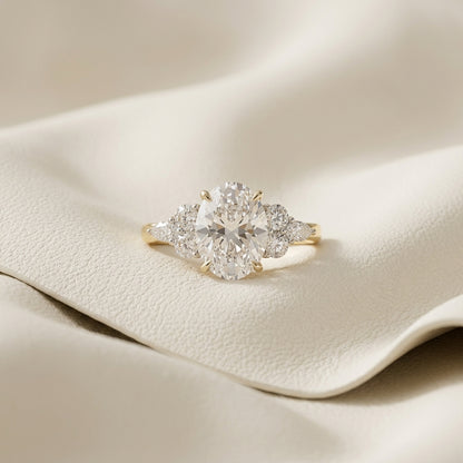 Oval lab grown diamond cluster engagement ring in 14K yellow gold
Prong-set oval center diamond with round and marquise accent clusters
E-F color VVS-VS lab grown diamond three-position cluster ring
Yellow gold oval cut diamond engagement ring, front view