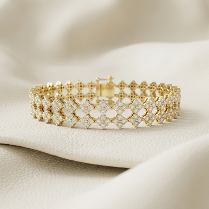 Triple-row round lab grown diamond tennis bracelet in yellow gold with floral-inspired links.
