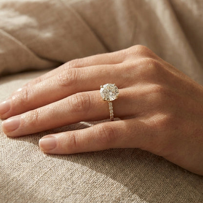 Round brilliant lab grown diamond solitaire engagement ring in 14K yellow gold
2.67 ct round diamond center held in a four-prong setting above a pavé band
Yellow gold pavé engagement ring with IGI certified round center stone
Classic round solitaire ring with sparkling pavé shoulders on a white background