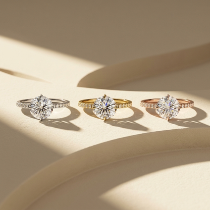 Round brilliant lab grown diamond solitaire engagement ring in 14K yellow gold
2.67 ct round diamond center held in a four-prong setting above a pavé band
Yellow gold pavé engagement ring with IGI certified round center stone
Classic round solitaire ring with sparkling pavé shoulders on a white background