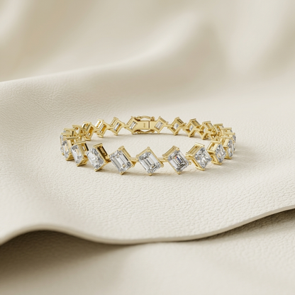Emerald and radiant cut lab grown diamond tennis bracelet in yellow gold.
