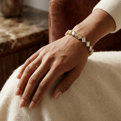 Fine yellow gold diamond tennis bracelet with modern articulated links.
