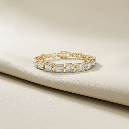 Emerald and radiant cut lab grown diamond tennis bracelet in yellow gold.
