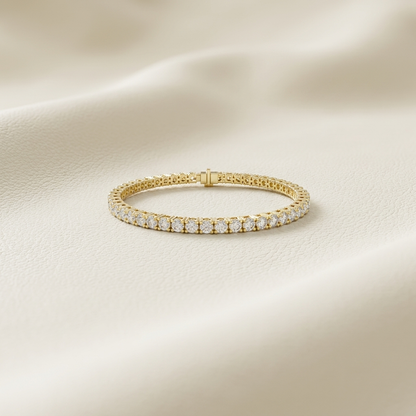 Round lab grown diamond tennis bracelet crafted in yellow gold with brilliant four-prong settings.
