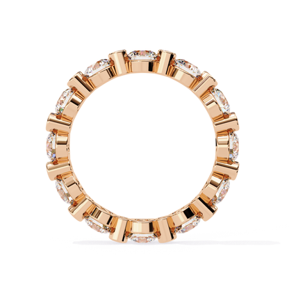 Inside view of a yellow gold eternity band with round diamonds in bezel settings
